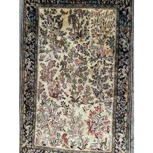 Very beautiful midcentury silk Qom rug with a garden design with birds and animals, and nice colours with a nice beige...