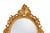 A vintage Rococo-style gold oval wall mirror with carved decorations. These mirrors typically feature delicate vines,...