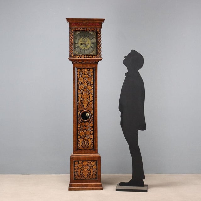 Francis reinolds kensington pendulum clock in walnut and burl walnut. The front is richly inlaid with floral motifs and...