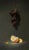 The artwork depicts a cluster of dark grapes suspended above a discarded orange peel, with a solitary bee hovering nearby....