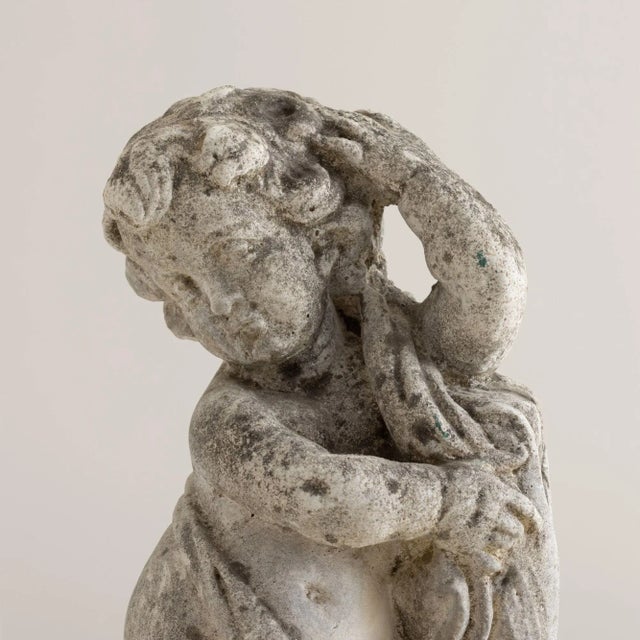 Early 20th century concrete Italian garden statue of cherub /putti figure, c. 1920. This charming, angelic statue is...