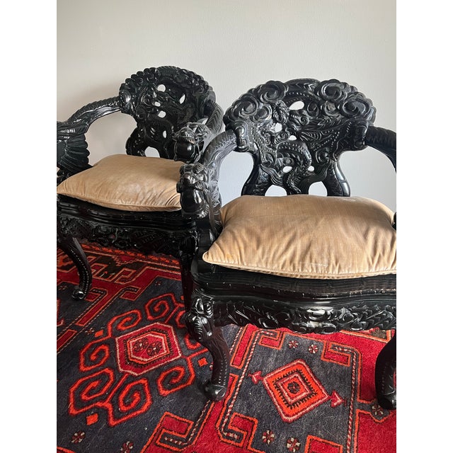 Beautiful pair of antique Japanese carved wood throne chairs. Black lacquer finish with custom seat cushions. Throne...