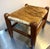 1950s-60s midcentury wood/cowhide footstool. Cowhide has some surface wear on the edges in a few places as shown.