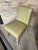 This chair has a sturdy build. It is a light green leather chair and wooden frame. It has a retro style and with a pop of...