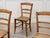 A beautiful set of six beechwood chairs dating from 1900, a testament to Swiss folk art. Their simple lines, with spindle...