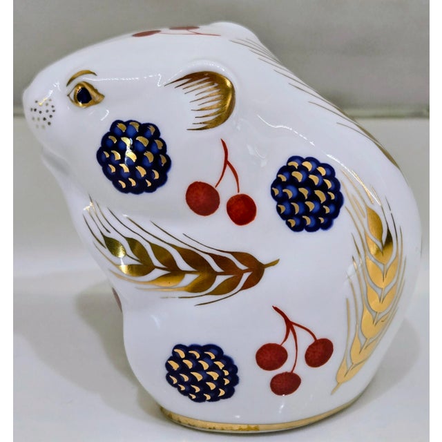 Charming Royal Crown Derby “Harvest Mouse” paperweight in fine English bone china, decorated in the classic Imari-inspired...