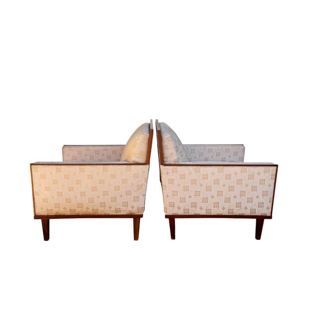 Stunning pair of mid century upholstered, lounge chairs outlined with walnut wood ready for reupholstering