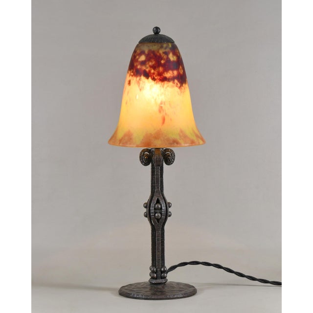 Daum A wonderful 1925-30 French art deco lamp in wrought iron of excellent quality. The forged base holds a nice coloured...