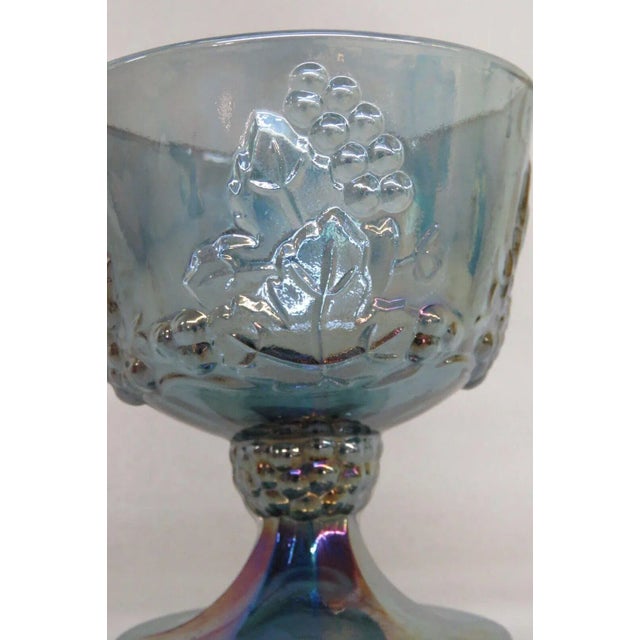 This lovely footed sugar bowl is made of carnival glass. This piece is made in the Harvest pattern used by Indiana Glass,...