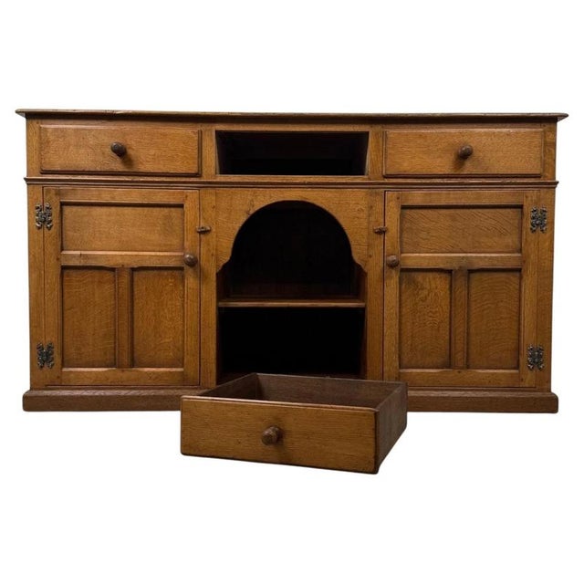 An exceptional and beautifully crafted 20th-century dresser base, finely constructed in golden oak and distinguished by...
