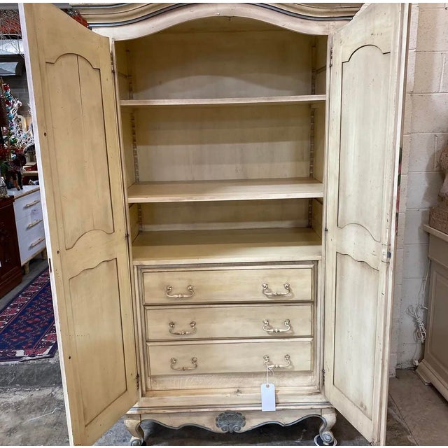 Beautiful solid wood, custom made and hand painted in France armoire with blue and pink ribbon and floral motif. This was...