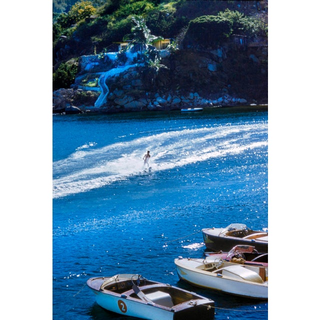 Acapulco Waterskier by Toni Frissell A water skier on the water nearing a group of motorboats in Acapulco in 1954. (Photo...