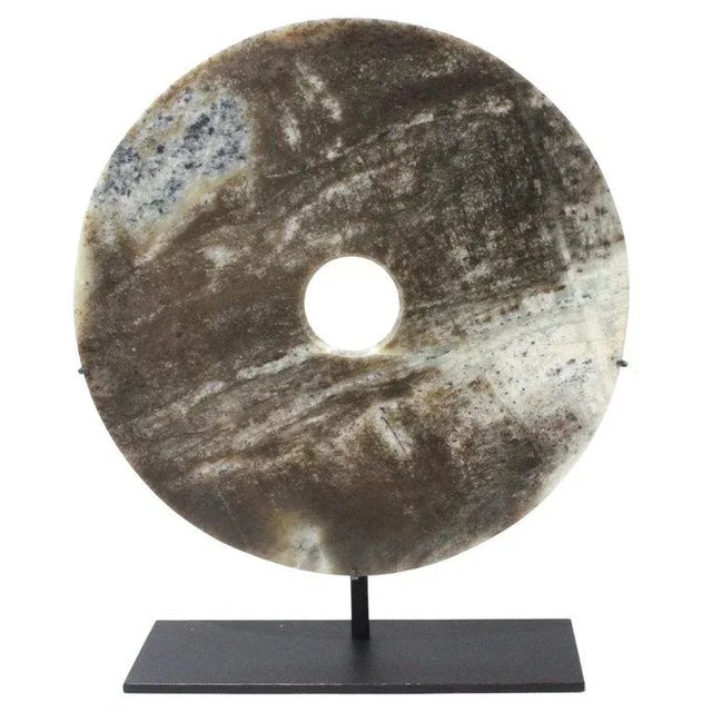 This stylish mounted jade disc will make a subtle statement with its form and use of materials. The stone has a mottled...