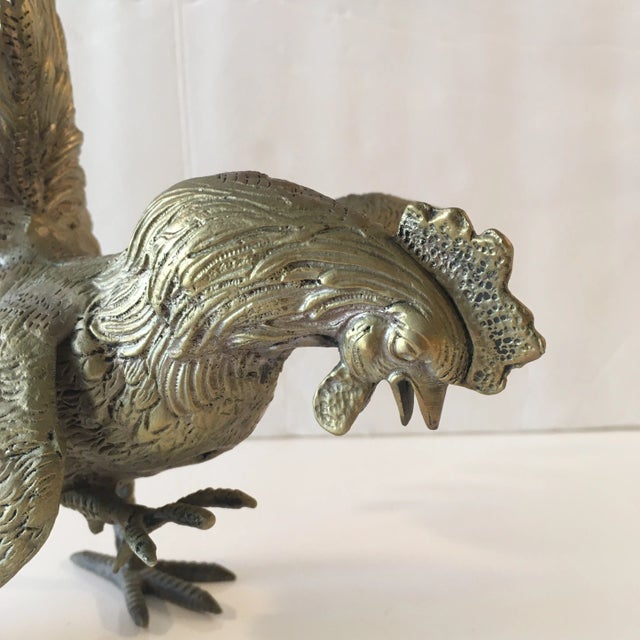Metal bird in a silvery/ bronze/ brass color. It's wings are in full open position and it's in motion. Hand crafted, this...
