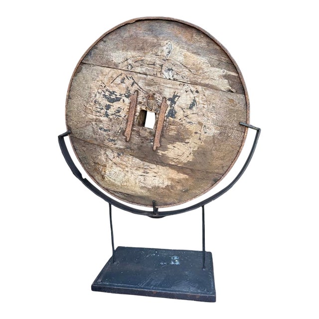 Antique Carved Wooden Wagon Wheel Sculpture Mounted on Iron Base. For Sale