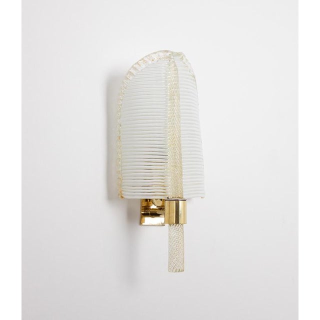 A beautiful pair of wall sconces made with 24-karat gold glass by barovier & toso, italy, 1970s. Both sconces are...