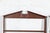 A complementary pair of tall, open wooden wall mounted plate racks with classical broken triangular pediments and four...