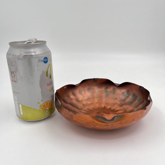 This handmade, hammered, solid copper bowl features a distinctive ruffled, flower-inspired edge. It’s perfect for holding...