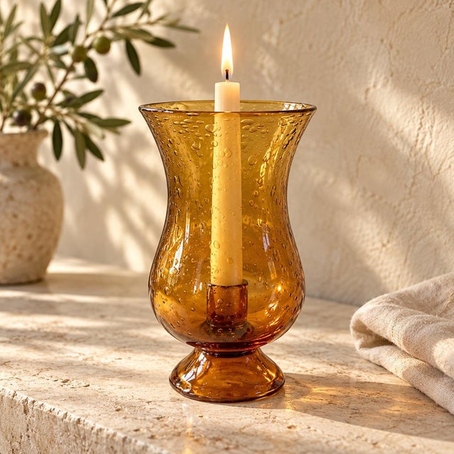 Marked Biot photophore crafted in hand-blown amber bubble glass. Its flared opening, softly narrowed waist, and rounded...