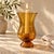 Marked Biot photophore crafted in hand-blown amber bubble glass. Its flared opening, softly narrowed waist, and rounded...