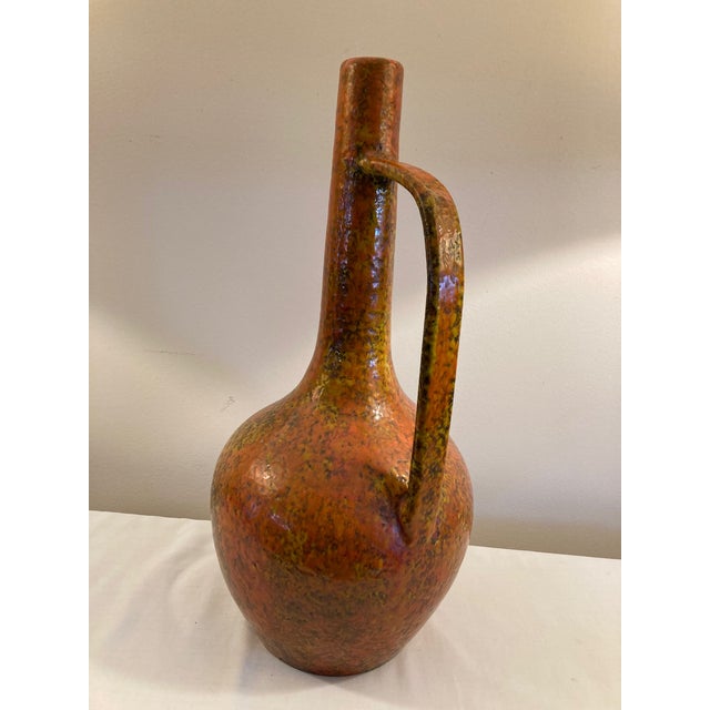 Very nice West German pottery jug with very long narrow neck & long handle. From the 1960s, has a nice volcano glaze....