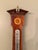 Comitti of London Sheraton style mahogany aneroid barometer with curl veneer, marquetry shell inlay and white/black...