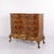Antique Baroque chest of drawers crafted in polished walnut and fitted with four drawers, decorative brass handles, and...