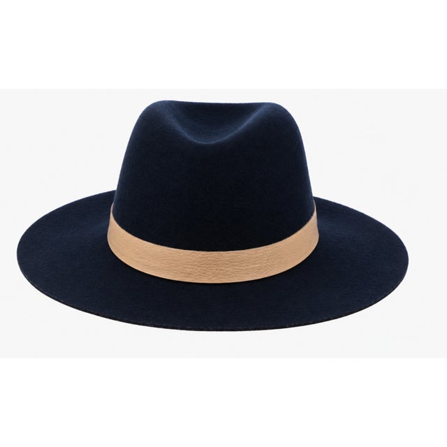 Elegant Janessa Leoné structured wool fedora in deep navy, finished with a rich caramel genuine leather band. A timeless,...