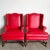 Elevate your home decor with the timeless elegance of the Traditional Red Faux Leather Wingback Chairs, offered as a pair....