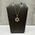 This Diamond Star of David necklace is crafted in 10kt yellow gold and features a meaningful Star of David pendant...