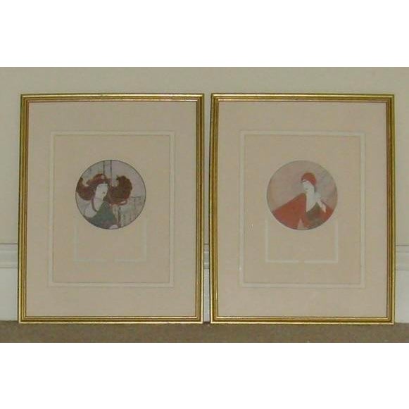 Set of two framed and glass enclosed art decor Asian inspired wall hangings of ladies. They are of both with wooden gold-...