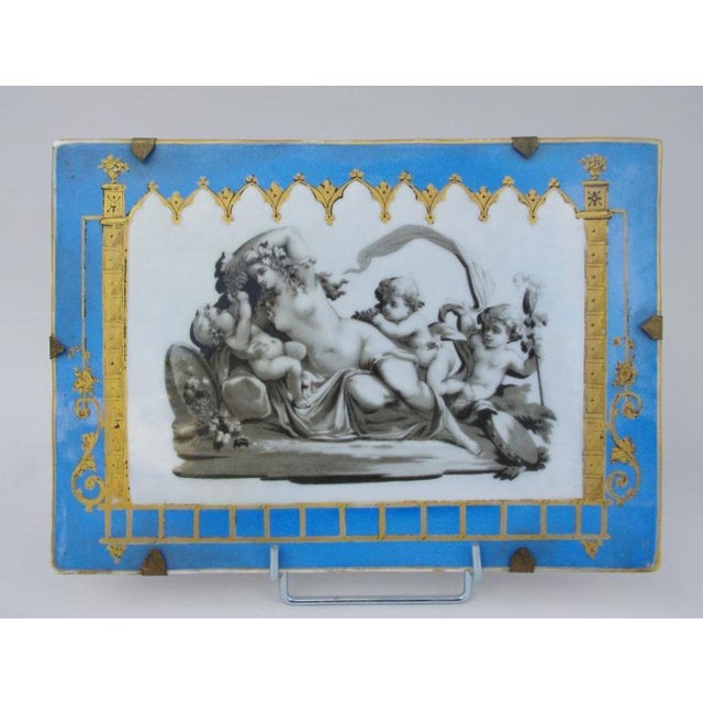 Pair of rectangular plates in porcelain representing antique scenes on cartouches with languished odalisques and nymphs...