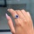 This Victorian-style ring showcases a 1.38 carat natural trillion-cut tanzanite, set in 18K white gold. The center stone...