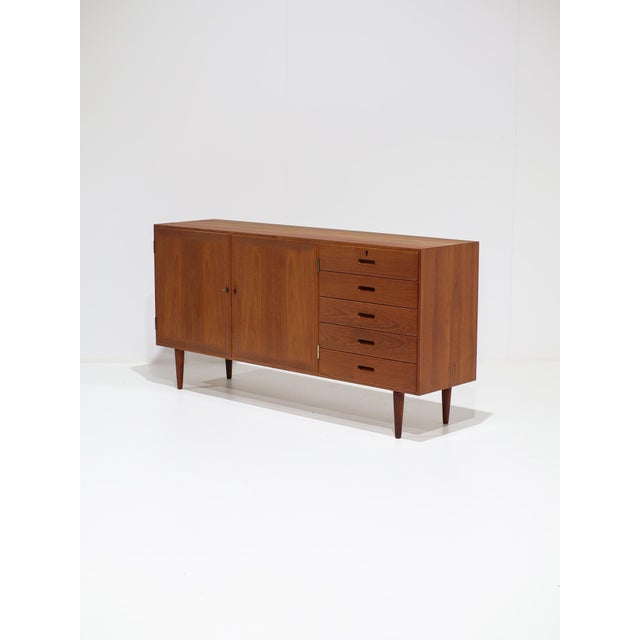 A beautiful sideboard designed by kai winding in denmark during the 1960s. Crafted from teak, the unit features a...
