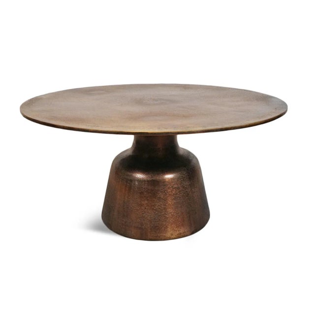 Modern round cast aluminum coffee table with beautiful antiqued brass finish. Each table is beautifully unique in exact...