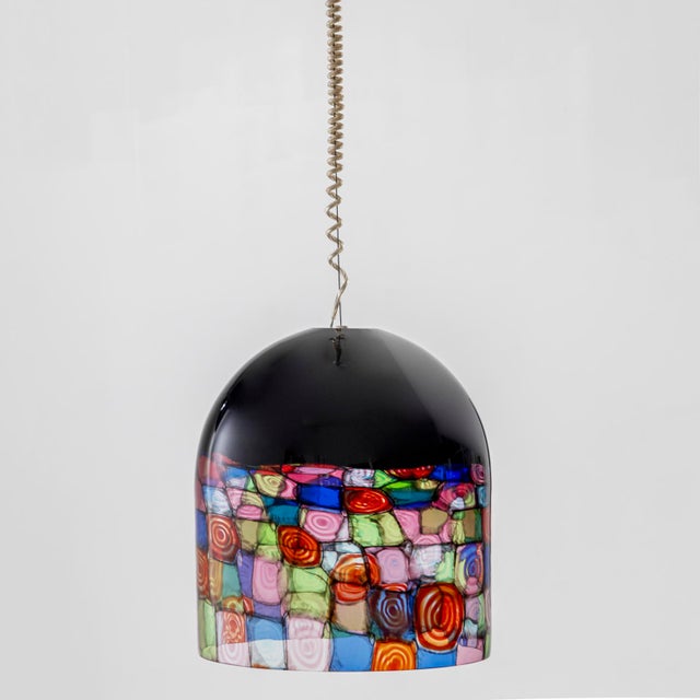 “Tinta” pendant lamp with a black, bell-shaped glass shade, the lower edge of which is worked in a colorful murrine...