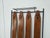 Vintage 1960s wall-mounted coat rack with a black lacquered iron frame supported by two height-adjustable brass feet. It...