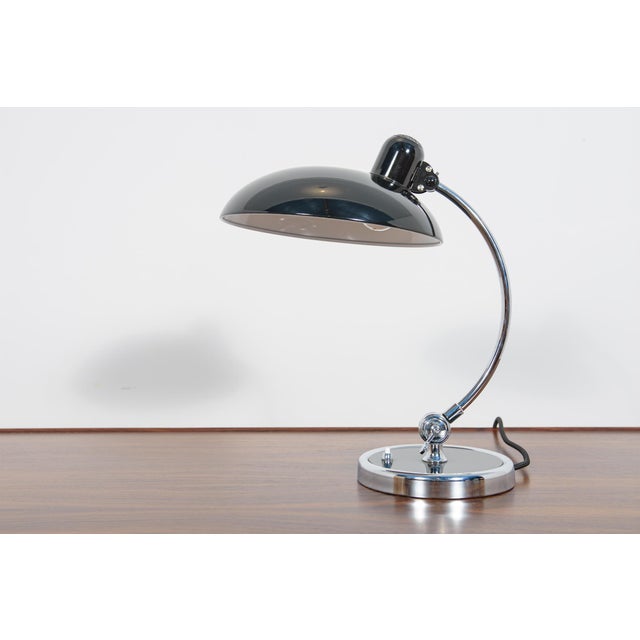 This kaiser idell 6631r luxus desk lamp was designed by german designer christian dell in 1936. The model is one of the...