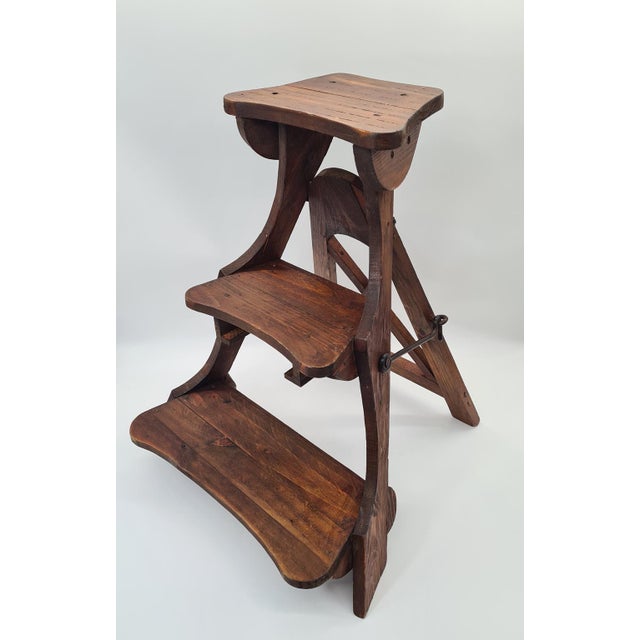 Original, foldable library steps made of solid wood, originating from Western Europe and dating from the mid-20th century....