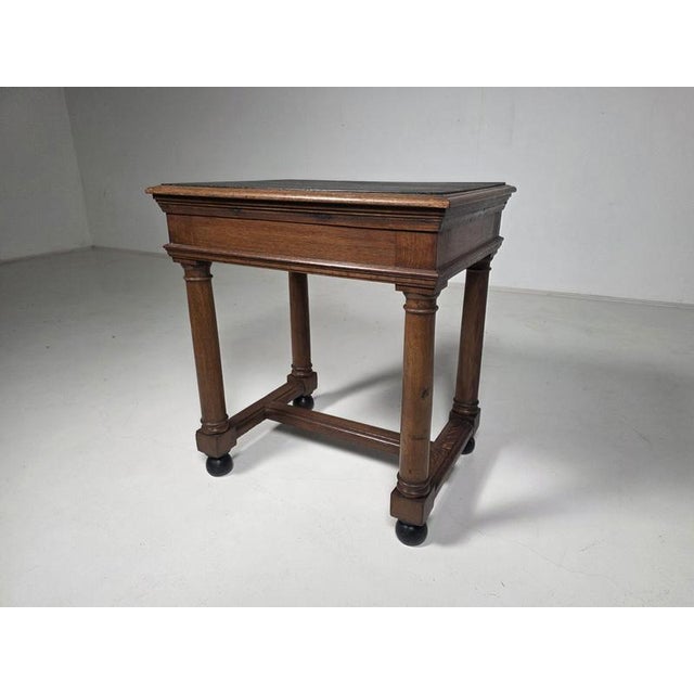 Dutch Amsterdam School side table dating from the 1930s. Crafted in solid oak with a contrasting black inset top. The...