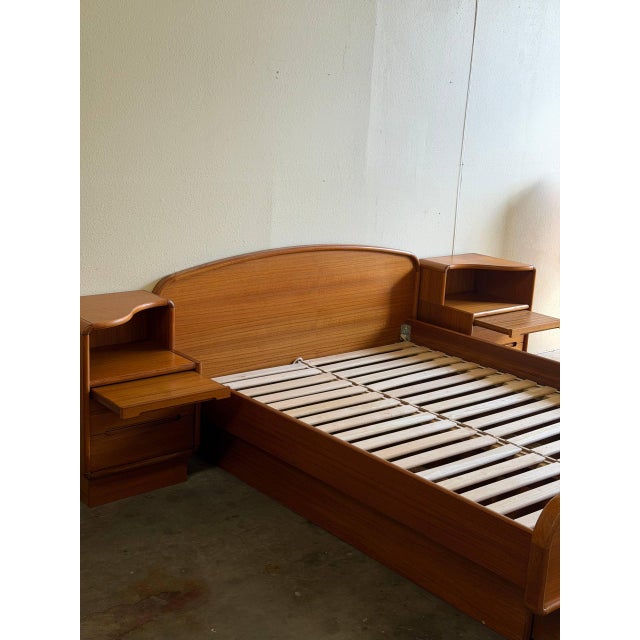 Beautiful Mid Century Modern teak queen bed set, crafted in Denmark, featuring a sculptural curved headboard and footboard...