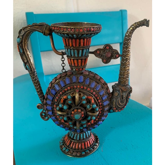 Striking antique Tibetan brass teapot (ewer form) featuring intricate hand-worked filigree and richly colored inlay of...