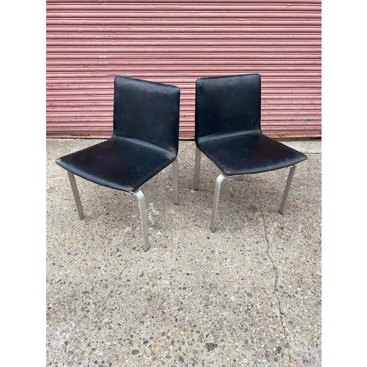 Jorgen Hoj Pair of elegant and handsome Aluminum and leather Chairs. Hoj was a student of Poul Kjaerholm and the influence...