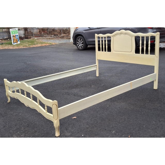 A Mid Century French Provincial Style Cream Painted and Partial Gilt Full Size Bedframe. Metal side rails. Measures 56.75"...