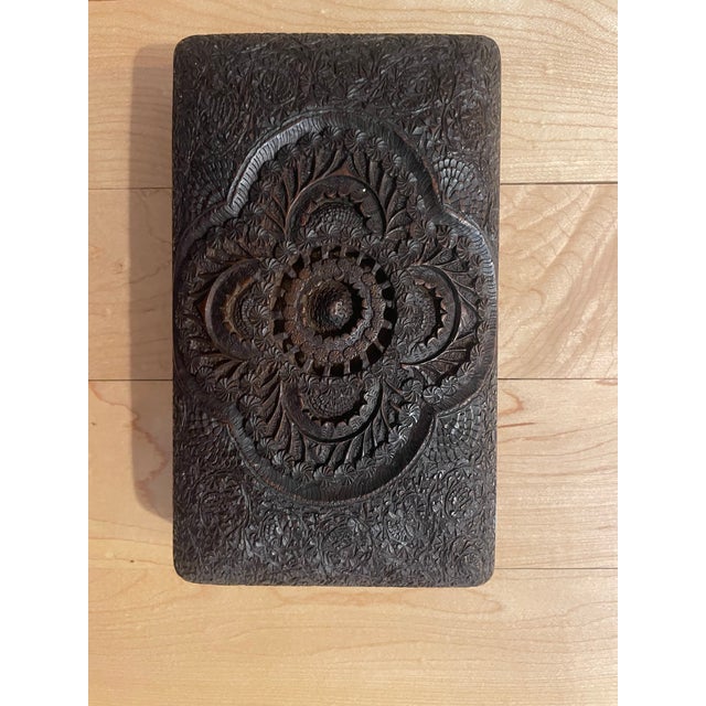 This stunning box is beautifully and ornately carved from a solid piece of wood. The top id curved and entirely carved,...