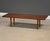 A mid century modern solid walnut coffee table with round wedged mortise and tenon legs. Made in USA. Professionally...