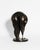 A contemporary figurative bronze of a woman bent low over her croquet mallet, her body folded at the waist into one...