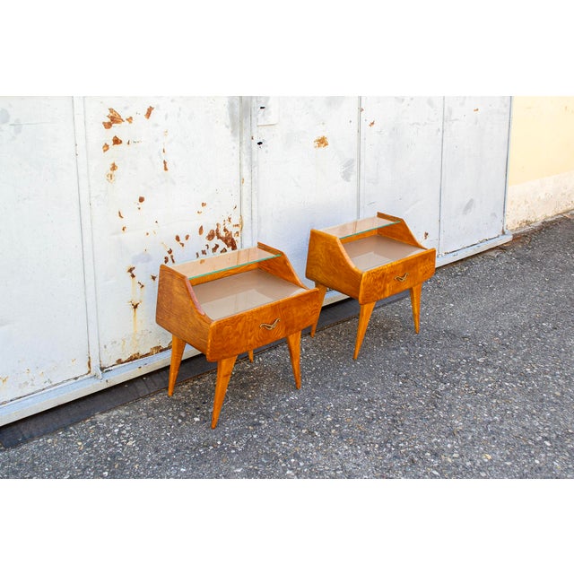 Pair of bedside tables with wooden frames, brass details, and glass tops. Made in Italy 1950s
