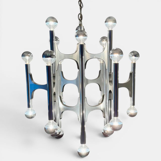 Vintage 1970s 24 candelabra light modernist chandelier designed by Gaetano Sciolari. This unique piece is a brushed chrome...