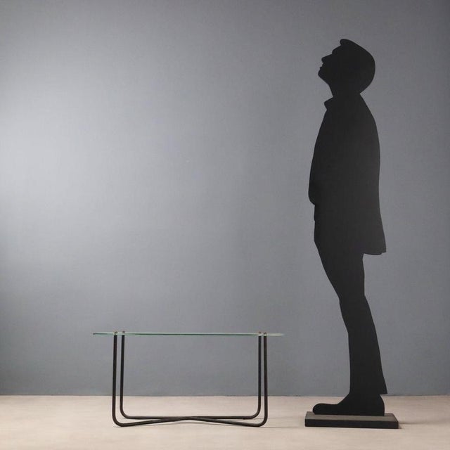 This 1950s/1960s coffee table designed by Jacques Hitier features simple, functional lines. Its lacquered metal legs lend...
